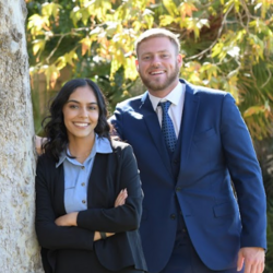Two UCR School of Business students in front of Anderson Hall