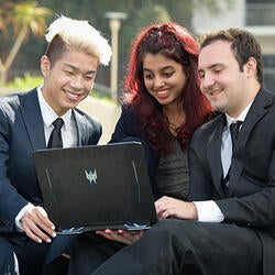 Three UCR Students looking at a computer